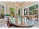 Dining area with large glass table, six chairs and view to landscaped backyard at 4522 Long Cove Dr, Denver, NC 28037