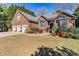 Charming brick home with a three-car garage and beautifully landscaped front yard, creating a welcoming curb appeal at 4522 Long Cove Dr, Denver, NC 28037