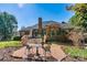 A spacious brick patio offers outdoor dining near a brick home with mature landscaping at 4522 Long Cove Dr, Denver, NC 28037