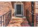Inviting front entrance with brick steps, black railings and decorative door at 4522 Long Cove Dr, Denver, NC 28037