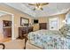 A spacious main bedroom features tray ceiling and a full bedroom set and television at 4522 Long Cove Dr, Denver, NC 28037