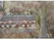 A beautiful aerial view of brick townhomes, each with a deck or patio, surrounded by lush landscaping and mature trees at 4605 Curraghmore Rd, Charlotte, NC 28210
