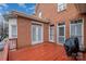 Outdoor deck featuring a grill, brick facade and outdoor seating area for entertaining at 4605 Curraghmore Rd, Charlotte, NC 28210