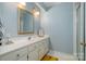 Bathroom with bright lighting, shower, and sink with ample storage space at 4605 Curraghmore Rd, Charlotte, NC 28210