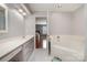 Bathroom featuring a bathtub and a vanity with framed mirror and great lighting at 4605 Curraghmore Rd, Charlotte, NC 28210