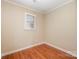 Cozy bedroom featuring hardwood floors, neutral paint and natural light from a window at 4605 Curraghmore Rd, Charlotte, NC 28210
