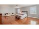 Spacious bedroom with hardwood floors, ceiling fan, and a comfortable sitting area at 4605 Curraghmore Rd, Charlotte, NC 28210