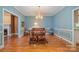 Bright dining room features hardwood floors and a beautiful chandelier at 4605 Curraghmore Rd, Charlotte, NC 28210