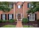 Charming two-story brick home featuring a classic design, well-maintained landscaping, and a welcoming front entrance at 4605 Curraghmore Rd, Charlotte, NC 28210