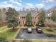 Charming brick townhomes feature well-manicured landscaping, mature trees, and ample parking for residents and guests at 4605 Curraghmore Rd, Charlotte, NC 28210