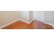 Hallway featuring hardwood floors, neutral paint, and bright white trim at 4605 Curraghmore Rd, Charlotte, NC 28210
