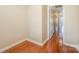 Hallway with hardwood floors leading to additional rooms; bright, neutral color scheme at 4605 Curraghmore Rd, Charlotte, NC 28210