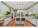 Spacious kitchen with an island, white cabinets, stainless steel appliances, and hardwood floors at 4605 Curraghmore Rd, Charlotte, NC 28210