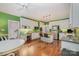 Bright kitchen features an island, white cabinets, stainless steel appliances, and hardwood floors at 4605 Curraghmore Rd, Charlotte, NC 28210