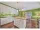 Open kitchen featuring white cabinetry, wooden island countertop, and hardwood flooring at 4605 Curraghmore Rd, Charlotte, NC 28210