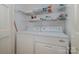 Convenient laundry room with washer, dryer, and shelving for storage at 4605 Curraghmore Rd, Charlotte, NC 28210