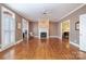 Spacious living room with a fireplace and elegant white trim at 4605 Curraghmore Rd, Charlotte, NC 28210