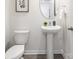 Charming half bathroom featuring a pedestal sink, neutral paint, and decorative mirror at 5050 Beargrass Dr, Dallas, NC 28034