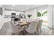 Open dining room connected to a modern kitchen with stainless steel appliances and island at 5050 Beargrass Dr, Dallas, NC 28034