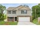 New two story home featuring stone accents, attached garage, and manicured lawn at 5050 Beargrass Dr, Dallas, NC 28034