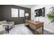 A staged office including stylish desk, lamps, decorative prints and neutral accent chair at 5050 Beargrass Dr, Dallas, NC 28034
