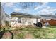 Fenced backyard with lawn and patio at 5120 Silabert Ave, Charlotte, NC 28205