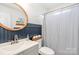 Bathroom with modern vanity and wainscoting detail at 5120 Silabert Ave, Charlotte, NC 28205