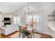 Dining area with modern lighting, flowing into a cozy living room at 5120 Silabert Ave, Charlotte, NC 28205