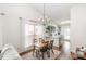 Open dining area with modern lighting, seamlessly connecting the living room and kitchen at 5120 Silabert Ave, Charlotte, NC 28205