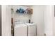 Bright laundry room with a white washer and dryer, plus wire shelving for storage at 5120 Silabert Ave, Charlotte, NC 28205