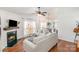 Bright living room with fireplace and hardwood floors open to dining and kitchen at 5120 Silabert Ave, Charlotte, NC 28205