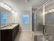 Modern bathroom with dual sink vanity, tile floors, and a glass-enclosed shower at 665 Cypress Glen Ln, Clover, SC 29710