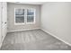 Cozy carpeted bedroom featuring a large window and a neutral color palette at 665 Cypress Glen Ln, Clover, SC 29710