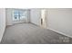 Spacious carpeted bedroom with ample natural light from large windows and adjacent bathroom access at 665 Cypress Glen Ln, Clover, SC 29710