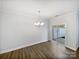 Dining room with hardwood floors, modern chandelier, and sliding door access to the backyard at 665 Cypress Glen Ln, Clover, SC 29710