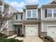 Charming townhome with a stone facade, attached garage, and well-maintained landscaping at 665 Cypress Glen Ln, Clover, SC 29710