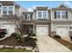 Charming townhome with a stone facade, attached garage, and well-maintained landscaping at 665 Cypress Glen Ln, Clover, SC 29710