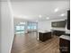 Open kitchen featuring dark wood cabinets, granite countertops, and stainless steel appliances at 665 Cypress Glen Ln, Clover, SC 29710