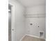 Convenient laundry room with tile flooring, shelving, and utility connections at 665 Cypress Glen Ln, Clover, SC 29710