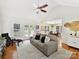 Spacious living room featuring hardwood floors, high ceilings, and a view into the dining area at 700 Cove Rd, Gastonia, NC 28052