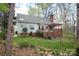 Scenic backyard showcasing a charming deck, pergola, and verdant greenery, perfect for outdoor relaxation at 7007 Chapparall Ln, Charlotte, NC 28215