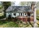 Backyard view featuring a wood deck with pergola and lush landscaping in a serene setting at 7007 Chapparall Ln, Charlotte, NC 28215