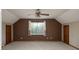 Spacious bedroom features large window with light, a ceiling fan, and closet doors, creating a comfortable retreat at 7007 Chapparall Ln, Charlotte, NC 28215