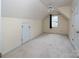 A spacious bedroom with a ceiling fan and dormer window, providing natural light at 7007 Chapparall Ln, Charlotte, NC 28215