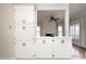 Kitchen features extensive cabinetry and a view of the living room fireplace, creating a warm and inviting space at 7007 Chapparall Ln, Charlotte, NC 28215