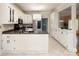 Kitchen featuring white cabinets, stainless steel appliances, a sink, and a breakfast bar area at 7007 Chapparall Ln, Charlotte, NC 28215