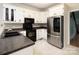 Kitchen featuring white cabinets, modern appliances, and contrasting countertops at 7007 Chapparall Ln, Charlotte, NC 28215