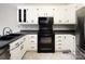 Kitchen featuring white cabinets, modern appliances, and contrasting countertops at 7007 Chapparall Ln, Charlotte, NC 28215
