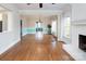 Bright living room with a fireplace, hardwood flooring, and large windows at 7007 Chapparall Ln, Charlotte, NC 28215