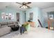 Spacious living room with seating, staircase and natural light at 7007 Chapparall Ln, Charlotte, NC 28215